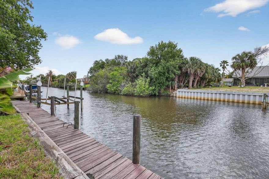 Welcome to Old Florida living. Waterfront home with ocean access, set on a canal with a private dock and seawall. The backyard is fully fenced with fruit trees and a refurbished saltwater pool (2024) within a screened enclosure, creating a private, relaxed setting. Inside, the major updates are done: new roof (2024), new AC (2024), new tile flooring (2026), and impact windows and doors. The layout is open with a split-bedroom design, vaulted ceilings, and natural light throughout. The garage features an epoxy floor. A waterfront home with the major work already behind you. This gorgeous home comes with 3 bedroom, 2 full baths plus a den/office. A must see.