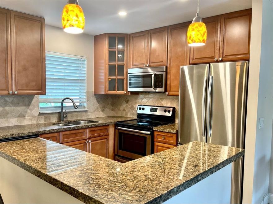 Welcome to the desirable Racquet Club in Oakland Park! This stunning 2 bedroom, 2 bathroom condo is fully upgraded & ready to become your new home. The sleek kitchen boasts beautiful granite countertops & all stainless steel appliances. Recent upgrades include the newly installed air conditioning, porcelain tile, & impact windows throughout. Relax in the gated community's pool, play a match on the tennis courts, or unwind in the lush tropical landscaping. With its convenient location, you'll enjoy quick access to I-95 & be just minutes from sun-drenched beaches, top-notch dining, shopping, and entertainment. Don't miss out on this opportunity to make the Racquet Club your home. Request a private showing today and experience the best in Florida living!