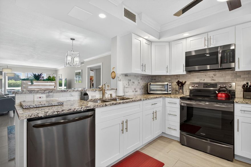 EXQUISITE 1ST FL DELUXE MODEL IN SOUGHT AFTER ARUBA VILLAGE ON THE GOLF COURSE! SPOTLESS! IMPACT WINDOWS AND DOORS. TILE FLOWS FROM ROOM TO ROOM, WASHER/DRYER IN UNIT! CROWN MOLDING, NO POPCORN. OPEN KITCHEN CONCEPT W/ GRANITE COUNTERS & SS APPLIANCES, TUMBLED MARBLE BACKSPLASH. BATHROOMS ELEGANTLY UPDATED W/ ATTENTION TO DETAIL. SPECTACULAR GOLF, CLUBHOUSE & WATER VIEWS. ACTIVE CLUBHOUSE W/ CLUBS & CLASSES GALORE!  WORK OUT IN THE STATE OF THE ART FITNESS CENTER. ARUBA POOL IS HEATED, HAS A BBQ AREA, MUSIC & FANS FOR YOUR ENJOYMENT. MAIN POOL AREA INCLUDES RESISITANCE POOL & HOT TUB! ENJOY PICKLEBALL, TENNIS, BILLIARDS, BOCCE BALL, THEATER & MORE. GATED COMMUNITY W/ 24 HR SECURITY. FREE SHUTTLE BUSES!  CLOSE TO GREAT EATERIES AND SHOPPING. THIS COUNTRY CLUB LIVING AT AN AFFORDABLE PRICE!