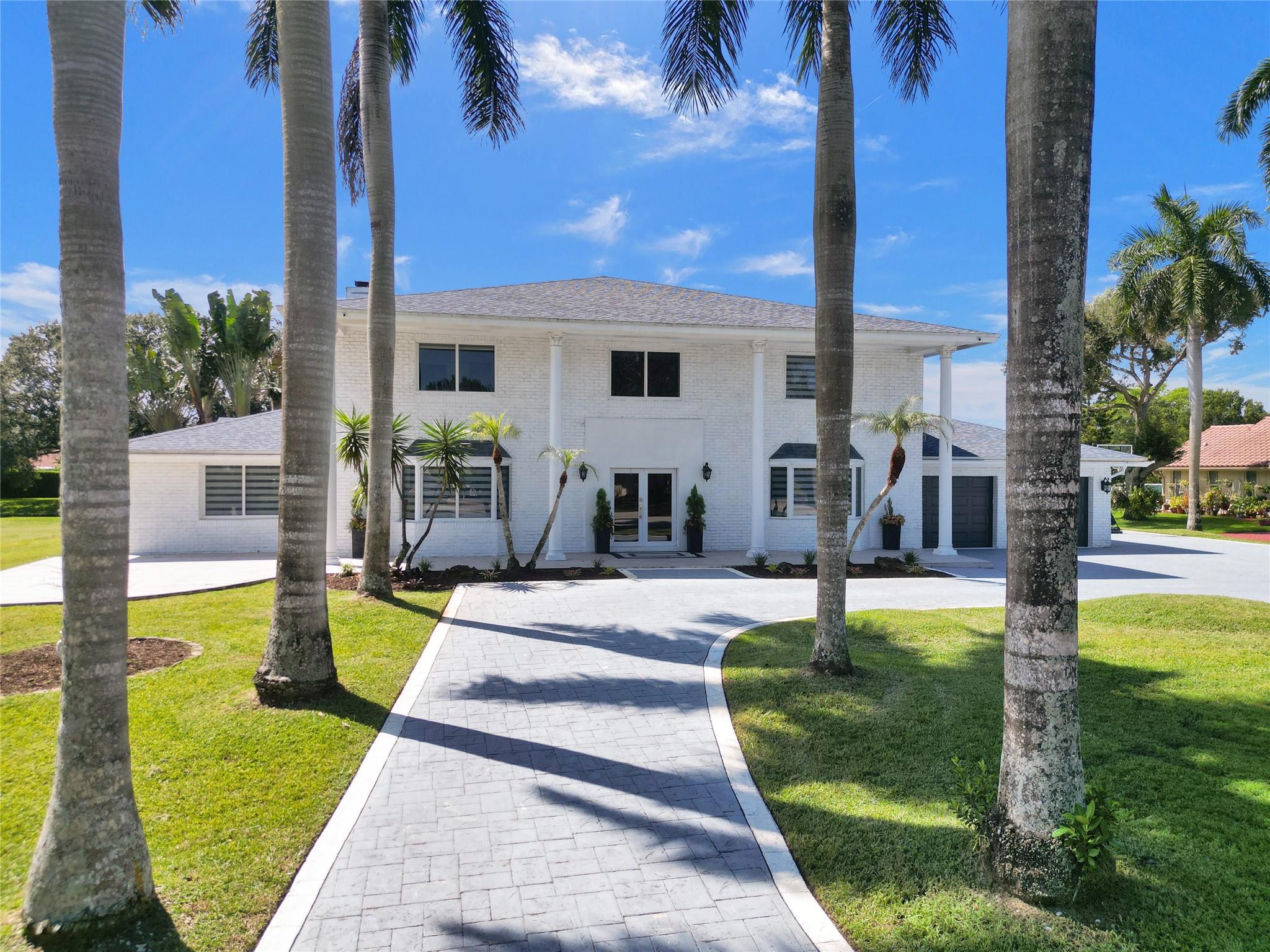 Welcome to this completely renovated&spacious estate on a sprawling 40,289 sqft lot. Immediately greeted by a grand circular driveway lined w/majestic palm trees;this expansive home features 6 bedrooms, one of which is used as an office w/a fireplace,& a bonus den off the primary—ideal for an addtl office, library, nursery, or gym & 5.5 bathrooms. Opulence exudes from the stunning foyer w/a spiral staircase & dripping crystal chandelier. Enjoy mirrored living rooms, 2 primary suites, a beautifully renovated kitchen, elegant bathrooms & gorgeous tile floors. The upstairs primary offers a fireplace & balcony w/views of the lush grounds & sparkling pool. Entertain under the covered patio & tiki hut. Full impact windows & doors complete this move-in-ready masterpiece! Easy to see, call today!