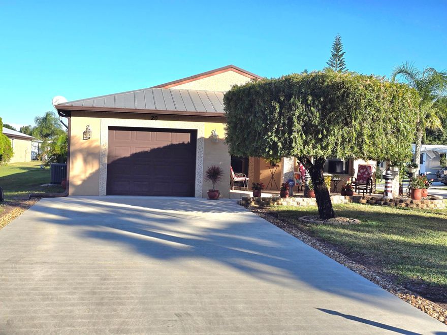 Very beautiful CBS with metal roof 2 bedroom, 2 bathroom 1 car garage house in a very nice community with a lot of amenities. Land lease includes all amenities, lawn maintenance and more. The house has accordion shutters, a nice covered lanai, Large driveway for 4 cars on a great corner lot. This one won't last long. Buyer to verify information and measurement.