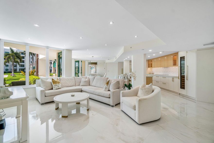 An immediate sense of arrival defines this exceptional, down-to-the-studs renovation in the coveted waterfront enclave of Mizner Court. This high-end ground-floor residence offers a rare combination of refined design, effortless access, and premier Southeastern exposure with Intracoastal views. Perfectly positioned on the front of the building, this 1,630-square-foot home showcases a thoughtfully designed split-bedroom layout with two bedrooms and two full baths. Every detail has been meticulously curated, blending sophisticated finishes with superior craftsmanship throughout. The reimagined open-concept kitchen serves as the centerpiece, appointed with quartz countertops, custom two-tone cabinetry, and a full suite of top-tier appliances including Sub-Zero refrigeration and wine storage along with Wolf oven, microwave, and cooktop. Expansive 48" x 48" porcelain tile flooring flows seamlessly throughout the residence, complemented by custom lighting, designer wall treatments, and electronic shades. Both bathrooms are exquisitely finished, with the primary suite offering dual vanities and an oversized walk-in shower, creating a spa-like retreat. The outdoor living experience is equally compelling—your private terrace is a true extension of the home, featuring custom matte-finished tile, direct walk-out access, and breathtaking Southeastern exposure overlooking the Intracoastal—ideal for morning light and coastal breezes. Mizner Court delivers a premier lifestyle in the heart of downtown Boca Raton, set across 13 acres of lush, manicured grounds adjacent to the iconic Boca Raton. Residents enjoy an unmatched suite of amenities including two resort-style heated pools, whirlpools, tennis courts, fitness centers, spa facilities, multiple social and entertaining spaces, and a waterfront pavilion. The community is fully gated with 24/7 security, offering covered parking, ample guest accommodations, on-site management, and a pet-friendly environment. A rare opportunity to own a turnkey waterfront residence defined by location, level of finish, and effortless ground-floor living.