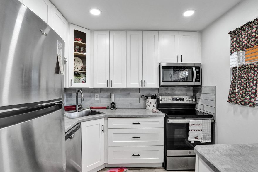 Spacious top floor corner unit located in a well-maintained 55+ community in Tamarac. This unit was completely renovated in the last 5 years including the AC & water heater. Laminate wood floors throughout the entire unit. The kitchen features white shaker cabinets & stainless steel appliances. Master bedroom features a large walk-in closet. Both bathrooms have been remodeled. Tons of parking. Ideally located minutes from shopping, dining, the Sawgrass Mills Mall, & close to excellent medical facilities. Tamarac is a senior-friendly city and offers a convenient shuttle bus service with pickup right at the community driveway. 50-year recertification completed in 2023. 40-year inspection completed in 2022. Association is financible with all required insurance coverage.