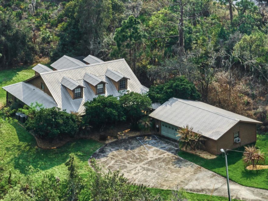 Looking for a 3-bed Single Family home in Sebring with acreage near Sebring International Race Track under $500,000? This 3-bedroom, 2.5 bath home offers 2,633 sq ft on a secluded 2 acre lot just five minutes from the track. Priced at $499,000, it features a spacious first floor primary suite with walk-in shower, large eat-in kitchen, and flex room that can serve as dining or additional living space. Upstairs includes two bedrooms, full bath, and loft. Wood floors and ceiling accents add character. Detached 2 car garage includes approx 400 sq ft office space, ideal for home business or studio. Metal roof installed 2008. Well and septic. Large open porch overlooking acreage. Needs updating, offering excellent opportunity to customize and add value in growing Sebring Florida.