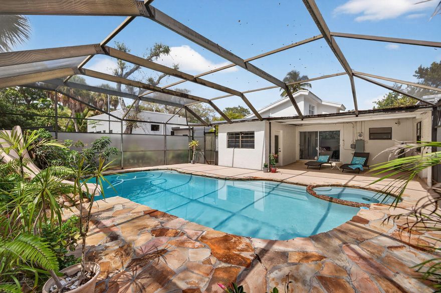 Welcome to your next dream home in the charming Shady Banks neighborhood of Fort Lauderdale! This unique 3 bedroom, 2 bathroom plus a den,  pool home is brimming with character, thoughtful upgrades, and endless possibilities for modern living. Enjoy a relaxed lifestyle with no HOA! Step inside to discover a layout designed to inspire. The spacious primary suite, added in 2005, boasts a huge loft space perfect for a den, meditation room or additional closet. Just off the kitchen, a flex area can be used as an office or reading room. Major updates include a new electrical panel and wiring (2021) and two water heaters (2021 & 2017). The washer and dryer are less than a year old, and the refrigerator is just two years young.   The large pool is screened-in and also has a covered patio. This unique layout has so much charm and is move-in ready! Shady Banks is a quick 15 minute drive to beautiful Fort Lauderdale Beach and is only a 5 minute drive to Fort Lauderdale Int'l Airport, making this home the perfect balance of serenity and accessibility.