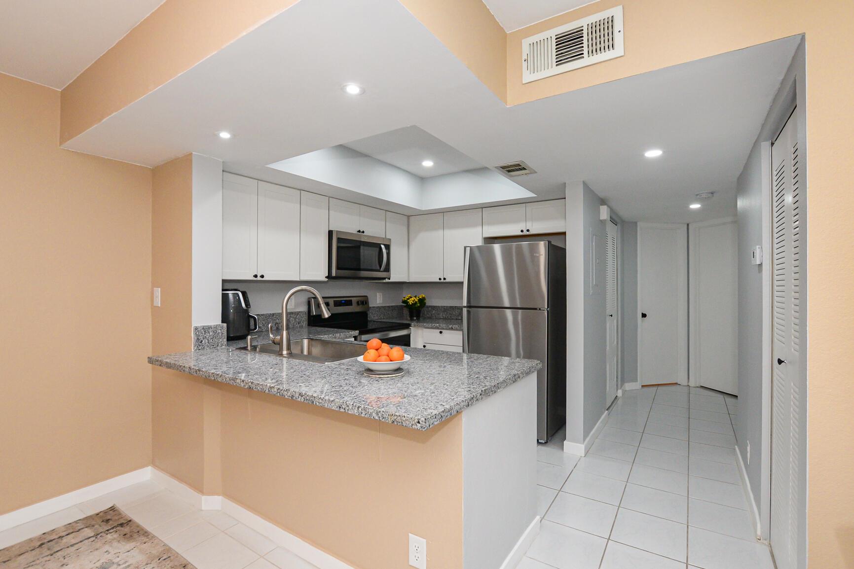 Unfurnished 2-Bedroom, 2-Bathroom Condo with Modern Updates and Prime Location. This beautifully updated 2-bedroom, 2-bathroom condo offers the perfect combination of comfort, style, and convenience. Located just minutes from Route 1, with easy access to the hospital, shopping, and a variety of restaurants. The kitchen has been fully updated with sleek granite countertops, new cabinets, and top-of-the-line stainless steel appliances, including a new stainless-steel sink with a gooseneck faucet. The newly remodeled bathrooms are both stylish and functional, offering modern finishes and comfort. Throughout the condo, you'll find brand-new tile flooring that adds a clean, contemporary touch to every room. Additional highlights include a screened-in balcony where you can enjoy the breeze,