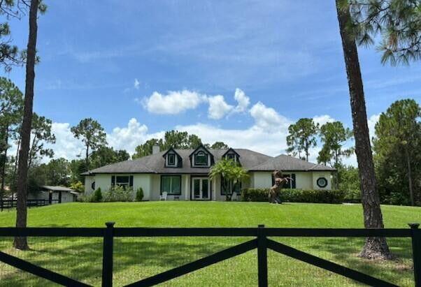 Equestrian Charm, Spacious Home with Vaulted Ceilings, Formal Living Room and Dining Room, Family Room Wood Burning Fireplace, Triple Sliders Open to Lanai, Spacious Kitchen Features Upgraded Cabinets, Stainless Steel Appliances, Breakfast Bar,Two Pantries,Breakfast Nook, Master Bedroom with Trey Ceiling, Tile Flooring, Master Bath has Oversized Shower and Roman Tub, Large Walk-In Closet, Impact Windows, Laundry Room, Cabana Bath, Covered Screened Lanai with Waterfall, Cabana Bath, New A/C unit with 10 Year Warranty Transferable to New Owner, Reverse Osmosis Water System, No Pond, 2 Stall Horse Barn with Tack & Feed Room, Large Paddock, Riding Arena 110 x 50, Wash Rack, Fully Fenced 1.5 Acre Corner Lot, NO HOA, Minutes to Westlake, Shopping and Schools, 15 Minutes to Showgrounds, Must See