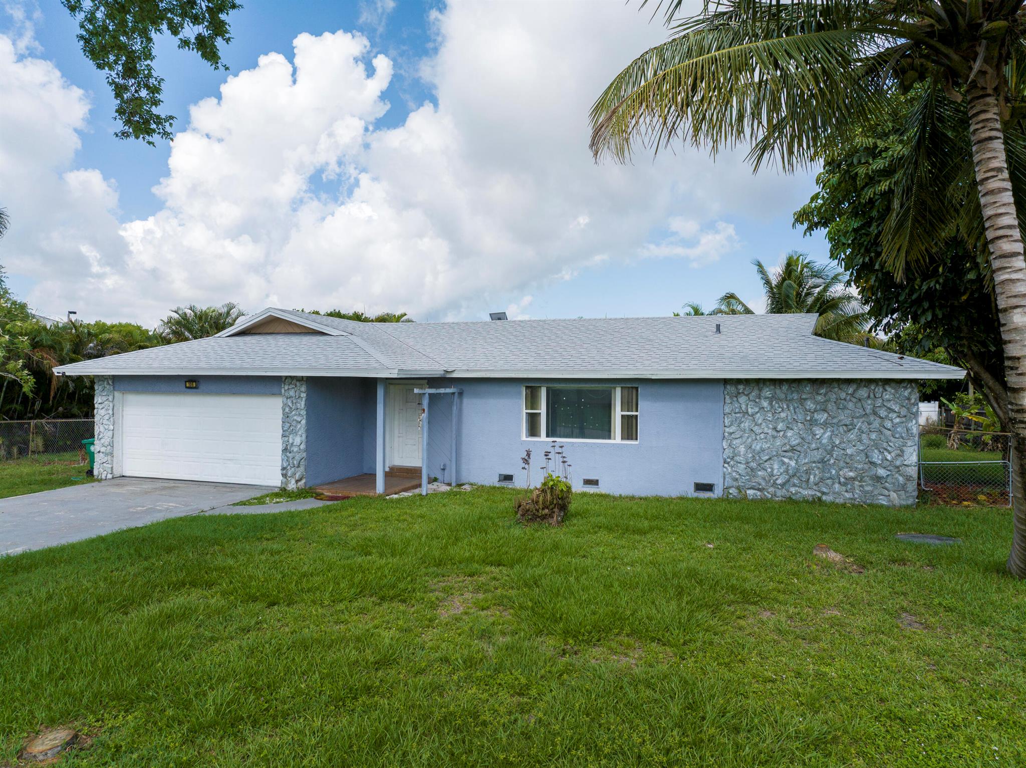 Port St Lucie Paradise: Room to Grow! Imagine your perfect Florida lifestyle in this beautiful split floor plan, nestled on a lush corner lot. Step inside and feel the bright living spaces in every room of the house. This 3/2/2 floorplan creates privacy, while the bonus room flexes to your lifestyle. Picture mornings on your covered patio, evenings lounging in your fully fenced landscaped yard, or hosting weekend BBQ's beneath the swaying palms. Plenty of room to add the pool of your dreams!This home isn't just move in ready-its turn key. The modern upgrades include granite counter tops, stainless steel appliances, LVP flooring, a newer roof (2023) and paid off solar panels!Don't miss this perfect family home, only a 10 Minute Drive to St Lucie West and highways.