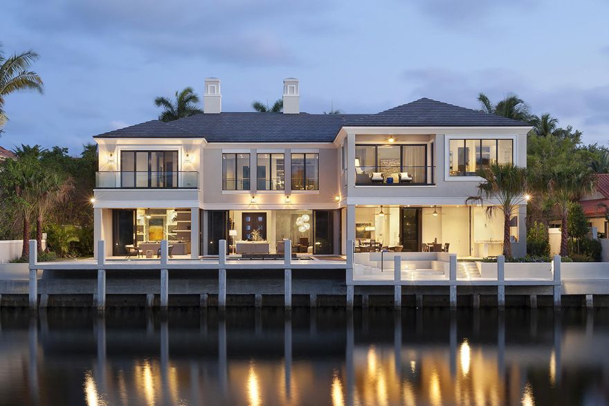 Gazing over the water to The Sanctuary’s nature preserve, this brand-new designer-furnished showplace mixes clean-lined Georgian-inspired architecture with chic modern interiors.

The information herein is believed to be accurate but is not guaranteed & may be subject to errors/omissions & be changed w/o notice. All measurements are approx. Buyer pays title insurance, Fl doc stamps-all other closing costs. Taxes on land only. Artful design epitomizes luxe modern living in this brand-new Sanctuary estate, embraced by a serene waterfront view overlooking the tree-cloaked nature preserve in a wide perspective, just one property from the point.  Clean-lined Georgian-inspired architecture takes a sophisticated twist in the subtly glamorous, furnished contemporary interiors of this five-bedroom residence, a collaboration of award-winning Bloomfield Construction, Affiniti Architects, and Marc-Michaels Interior Design, twice named on Architectural Digest's annual AD100 list of the world's top architects and designers.  In the muted tones of a tranquil coastal-themed palette, elegant minimalism emphasizes the design of each carefully thought-out detail, with functional elements crafted as objects of beauty.

The airy open living spaces center on a stunning two-story great room anchored by a marble-slab ribbon fireplace in a sleek paneled wall, across from the glass-encased wine room where stainless steel cables form a "floating" display system with a chic industrial edge.   Throughout the main level, transparent walls of retractable glass doors play up the gorgeous waterfront view and freely interconnect with outdoor spaces setting the scene for entertaining with dining/lounge areas around the Hamptons-style pool, infinity-edge spa, and sunken fire-pit by the large yacht dock.  Fashioned through a uniquely creative vision, this exquisite Sanctuary estate is one-of-a-kind.

Location
Sanctuary Drive, Boca Raton, Florida.  One of the nation's most prestigious communities, The Sanctuary is a world-famous yachting enclave featuring a 20-slip marina, Har-Tru tennis courts, and a pristine bird/wildlife preserve of 27Â± lush acres.  Supreme privacy is ensured with a guard-gated entry and the community's own road and water patrol services.  Peaceful and secluded, this prized Boca Raton address is only minutes from the Atlantic Ocean beachfront, the legendary Boca Raton Resort & Club, Mizner Park's world-class shopping and dining, and Boca Raton's private executive airport.

Property
On 106Â± feet of deepwater shoreline with yacht dockage, this clean-lined Georgian-inspired estate gives a wide viewpoint over the water to the nature preserve.  The sublime resort-style outdoor entertainment space centers on the immense Hamptons-style pool with stepping stones that separate the infinity-edge spa.  Finished in stone and high-end wood-look porcelain tile, several lounge areas around the pool feature two loggias, one served by a full summer kitchen.  Built-in sunken seating surrounds the fire-pit.

Residence
Chic modern elegance refines this designer-furnished residence of 9,436Â± total square feet which includes five bedrooms, six full and two half baths, laundry/utility rooms on both levels, an elevator, and a three-bay garage with high ceilings that can accommodate car lifts.  Window walls all across the water side give breathtaking views and diffuse natural light.  Villa Caprisi Messina hardwood plank floors carry through the open living areas, with other design elements of rift-cut oak.

First Floor:  Stepping inside the double-door entry, the foyer captures views of the waterside pool patio through the double-height window-walled great room, giving the feel of a sophisticated contemporary loft, featuring a London Sky marble-slab ribbon fireplace and a glass-encased wine display room.  The foyer is set off by a floating staircase with glass-and-bronze-finish balustrade, with the formal powder room adjacent.  Separated from the foyer by an artistic bronze-finish screen, the elegant open dining room is served by a butler's pantry.  A functional work of art, the epicurean's kitchen has high-gloss white lacquer cabinetry, Carrara marble counters, and stainless steel display shelves in a mosaic-tiled niche.  High-end appliances include the Sub-Zero refrigerator/freezer, dual Miele dishwashers, six-burner Wolf gas range, and Wolf double ovens, microwave, and warming drawer.  In a seamless layout, the family room and breakfast area with "floating" wood ceiling are wrapped with retractable glass walls that fully open to the poolside loggia.  The powder room doubles as the cabana bath.  Off the great room, the club room/lounge has a River Bordeaux marble wet bar that separates the office area with built-in desk.

Second Floor:  Ascending the staircase or elevator arrives at a bridge hallway leading to the dramatic loft, open to the great room below.  In the west wing, the large master suite creates a relaxing private sanctuary with a glass-railed waterside balcony and morning bar.  Walk-in closets accompany the two spa-like master baths, one done in glass-tile mosaics and marble with a sculptural shower/tub.  In the east wing is a VIP suite with waterside balcony, walk-in closet, and luxurious bath.  Three more bedrooms also have walk-in closets and private baths.

Disclaimer: The information provided herein including but not limited to measurements, square footages, lot sizes, calculations and statistics have been obtained and conveyed from third parties such as the applicable Multiple Listing Service, public records as well as other sources. All information including that produced by the Sellers or Listing Company are subject to errors, omissions or changes without notice and should be independently verified by any prospect for the purchase of a Property.  The Sellers and Listing Company expressly disclaim any warranty or representation regarding all enclosed information.  Prospects' use of any information herein is acknowledgement of this disclaimer and that Prospect shall perform their own due diligence.  Prospects shall not rely on this information when entering into a contract for sale and purchase.  Some affiliations may not be applicable to certain geographic areas. If your property is currently listed, please do not consider this a solicitation.   In the event a Buyer defaults, no commission will be paid to either Broker on the Deposits retained by the Seller. "No Commissions Paid until Title Passes."    Buyer pays title insurance, Florida documentary stamps, and all other closing costs for New Construction and land use. Copyright 2016 Listing Company.  All Rights Reserved.