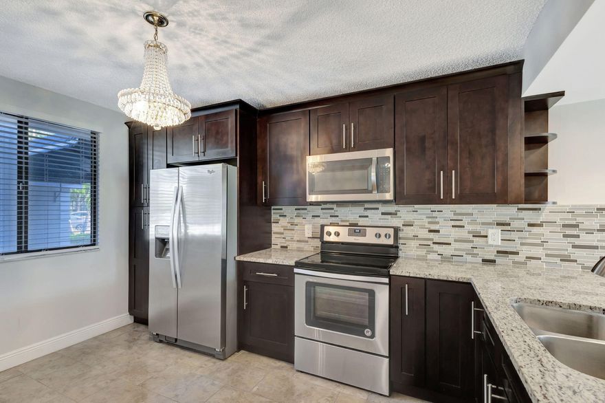 This updated centrally located 2/2 with bonus room in the heart of Palm Beach County features tile throughout, SS appliances, washer dryer inside and a porch that opens to green space near pool.  Loads of amenities under the HOA and the Master Association of Villages of Palm Beach.  All the creature comforts just minutes away:  Publix, restaurants, the Tanger Outlets, PBIA, the beaches and Singer Island. Easy access to I95. Easy to show, vacant on lockbox.