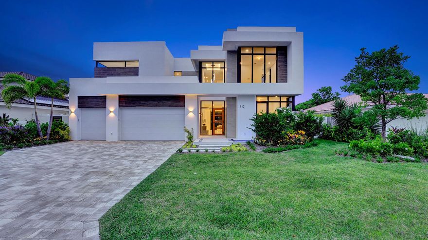 A masterpiece of modern design by acclaimed builder Core 4 Homes, this brand-new coastal residence is perfectly positioned just two blocks from private beach access in the exclusive neighborhood of Spanish River Land. Offering the ultimate blend of luxury and location, this home sets a new standard for refined seaside living. Designed with thoughtful detail and high-end finishes throughout, the home offers over 4,400 square feet of living space, including five bedrooms and five bathrooms. A downstairs guest suite adds flexibility, while each upstairs bedroom features its own private en-suite bath.From the moment you arrive, the home makes a bold first impression--floating entry steps, lush tropical landscaping, and a peaceful water feature set the stage for what's inside.