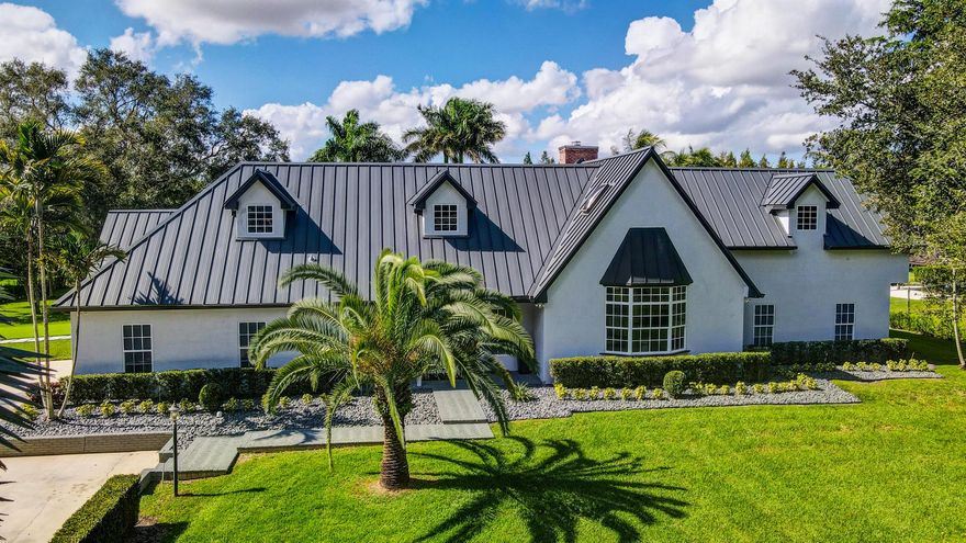 Elegantly renovated custom estate home has 6500 square feet of living space under air with canal views and no visual back neighbors.  5 bedrooms, 4.5 bathrooms, large custom eat-in kitchen, formal living, formal dining, den/office, library, gym and 2 car garage. Custom kitchen has two islands, two sinks, two dishwashers, professional appliances, gas range and double oven, Cambria quartz counters, custom cabinetry, and a walk-in pantry/mudroom that has a service entry. Master is in a private wing, has an office nook, and a separate shoe and bag closet. All bedrooms have custom window treatments and built-in closets with lighting. Home has a 250 gallon propane tank, central vac, security system, indoor and outdoor cameras, 4 holes of putting green, a large playground with turf, and