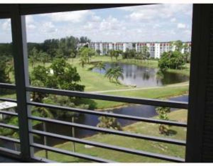 UPDATED CORNER CONDO WITH LONG, WIDE GOLF & WATER VIEWS. THIS BRIGHT CONDO HAS A WINDOW IN THE DINING ROOM & PORCELAIN TILING THROUGHOUT & WAS JUST PAINTED. OTHER FEATURES INCLUDE NEWER KITCHEN CABINETRY& GRANITE COUNTERTOPS IN THE EAT-IN KITCHEN THAT OPENS ONTO THE 25' BALCONY. THIS BALCONY ALSO OPENS INTO THE LIVING ROOM & MASTER BEDROOM. BOTH BATHROOMS HAVE UPDATED VANITIES. A REAL INSURANCE PLUS: IMPACT GLASS WINDOWS (EXCEPT FOR SLIDERS)& HURRICANE ACCORDION SHUTTERS ON THE BALCONY (2007. THE AMBASSADOR BUILDING HAS FULL SIZE WASHER & DRYERS, SPACIOUS ROOMS, VOLUME CEILINGS & A GREAT LOCATION NEXT DOOR TO THE CLUBHOUSE WITH ITS TENNIS, PAY-AS-YOU-PLAY GOLF, EXERCISE ROOM, CAFE, WI-FI, CLASSES,LECTURES, MOVIES, TRIPS, SHOWS IN SEASON.  THE AMBASSADOR POOL IS AT THE NORTH END OF BLDG.