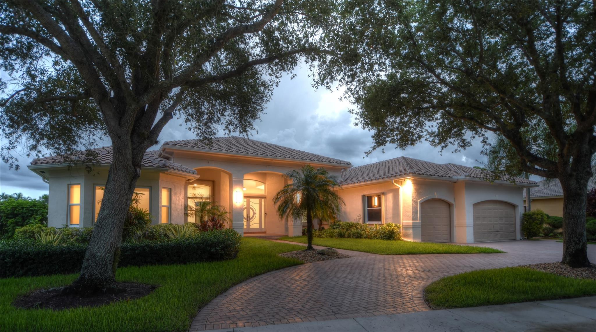 This home's updated transitional contemporary design, with modern lines softened by elegant, neutral furnishings and subtle traditional influences, utilizes materials that create a serene and sophisticated feel in the rooms. They feel inviting, luxurious, and timeless, perfect for both intimate living and upscale entertaining. The chef's kitchen features updated appliances and high-end custom cabinetry. This 4130 sq. foot living area features 4 bedrooms, with the optional 5th bedroom or office use, and 4 bathrooms. The significant financial impacts have been addressed: New Roof (2024), New A/C Units (2024), Refinished Heated Pool, 40K Cummings Propane Generator, Impact Sliding Patio Doors, Accordion Shutters on all windows. This is truly a must-see lakefront property for luxury living.