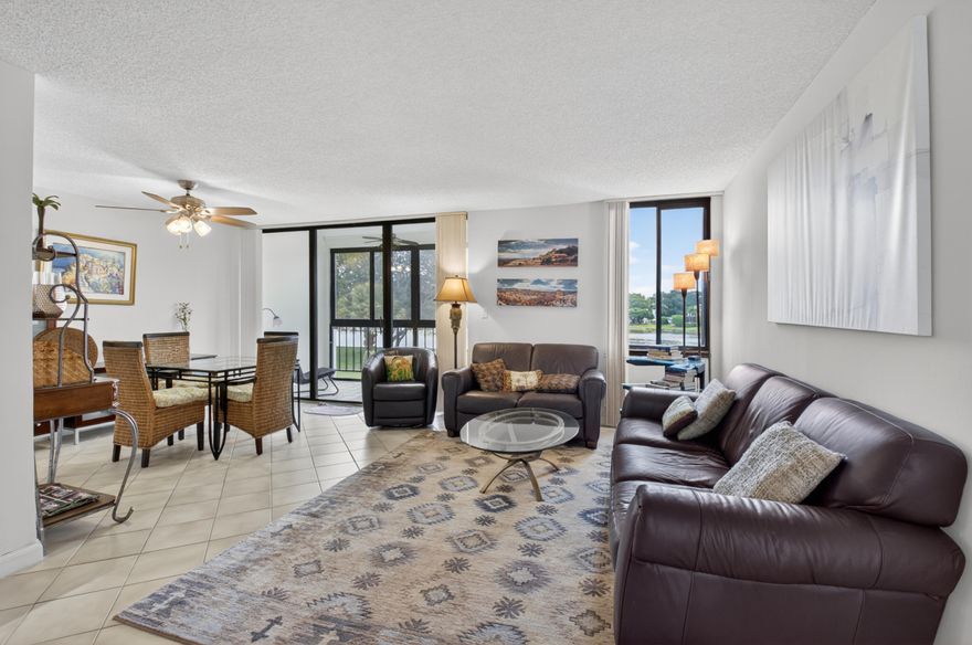 Located behind the gates of Boca West Country Club, this clean unit is available for off-season rental until September 25th. Pet-friendly and assigned parking.  Nice enclosed porch overlooking a wide lake area. No Membership. Please coordinate with the Listing Agent for gate access.  All measurements are approximate.