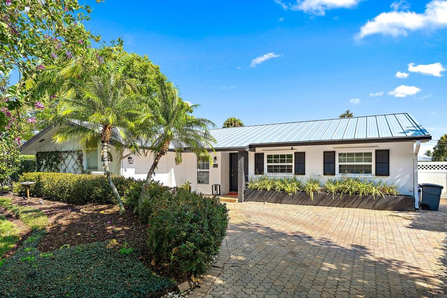 Oversized lot in the heart of North Palm Beach with room for a pool and minutes to the beach! Beautiful 4 BR home in the desirable Village of North Palm Beach Golf Cart community offering 1,826 living sq ft on a .29-acre lot with lush landscaping and paver driveway. Some features include a newer metal roof 2023, A/C 2018, water heater 2022, fresh interior/exterior paint, new white oak floor, saltillo tile, attached garage, and large patio. The eat-in kitchen flows effortlessly into the open dining and living areas, while a sliding glass door leads to a spacious backyard and private patio perfect for entertaining. Primary suite with a en-suite bath and walk-in shower. Close to beaches, marinas, dining, shopping, and the Jack Nicklaus Signature golf course at North Palm Beach Country Club.