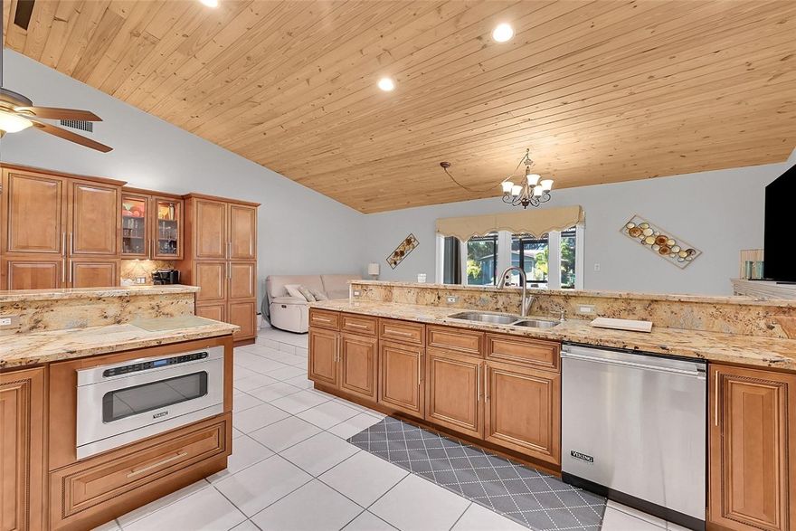 THIS CAPTIVATING HOME, WITH HIGH-CEILINGS WITH AN EXPANSIVE 5 BEDROOM 4 BATH SPLIT FLOOR PLAN SITS ON A 51,209 SQUARE FOOT LOT OVERLOOKING A BEAUTIFULLY PRIVATE POOLSIDE OASIS. OWNERS INVESTED OVER $100,000 ON A SALT CHLORINATED POOL, BEAUTIFUL HEAT-RESISTANT TILE WHICH SURROUNDS THE POOL AREA AND SCREENED IN LARGE SEPARATE PATIO.  LARGE MASTER SUITE WITH A JACUZZI TUB. OPEN CONCEPT GOURMET KITCHEN FEATURING TOP OF THE LINE STAINLESS STEEL VIKING APPLIANCES, GRANITE COUNTERTOPS, HIGH WOOD BEAM CEILINGS. ELECTRIC FENCED GATE, EXPANSIVE DRIVEWAY. IMPACT WINDOWS, NEWER ROOF (APX 4 YEARS OLD). SEPARATE STAND ALONE OVERSIZED TWO CAR GARAGE WITH DUAL ENTRANCES, BARN AND OVERSIZED SHED. PRICED RIGHT WITH SO MANY PLUSES!!! THIS HOME WILL NOT DISAPPOINT.