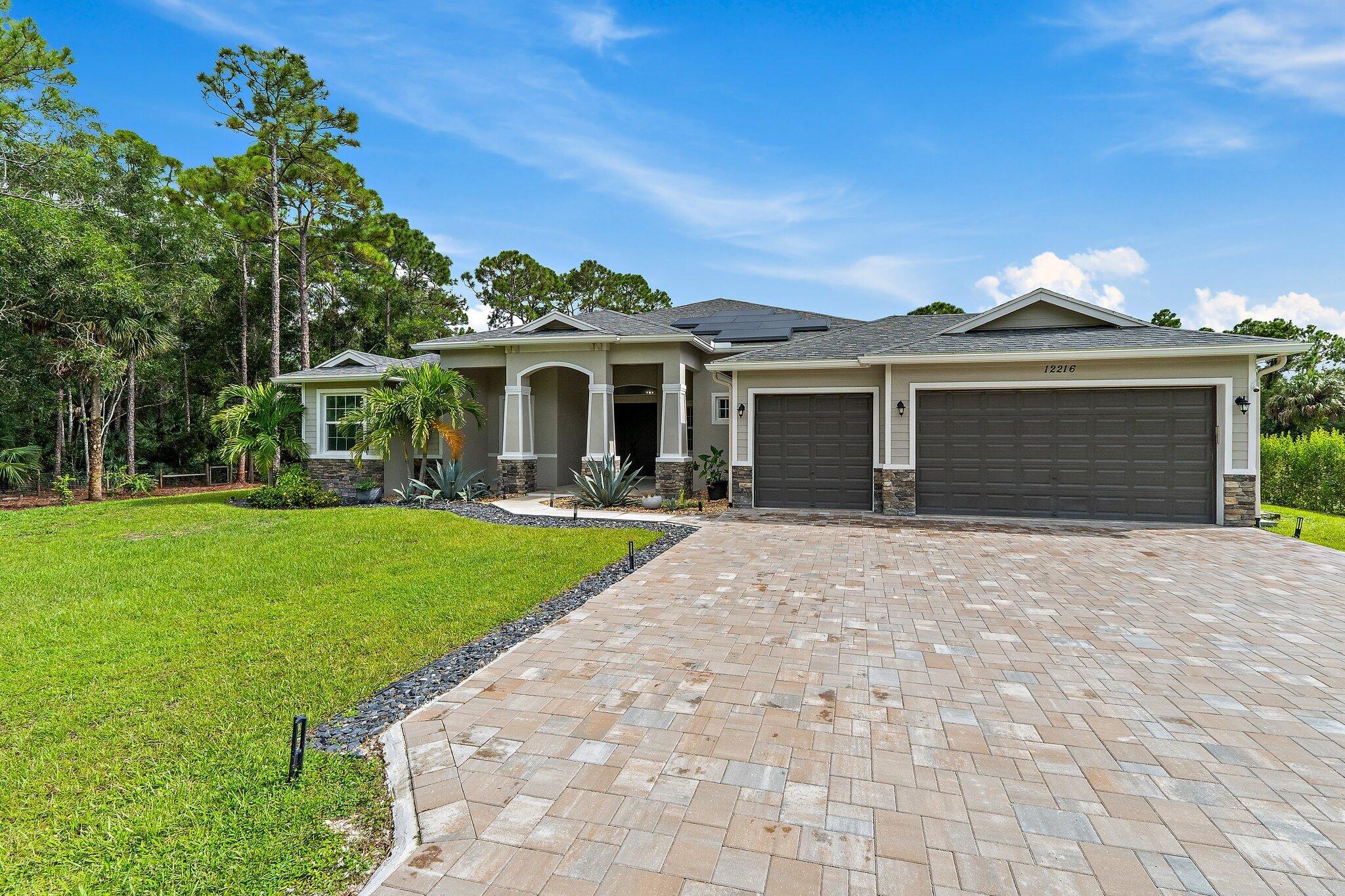 Jupiter Farms pool home on 1.5 acres with no HOA. Built in 2021, this modern farmhouse offers 4 bedrooms plus office, 4.5 baths, and 3,051 sq. ft. under air (4,415 total). Open layout with wide-plank laminate hardwood, high ceilings, and natural light. Kitchen with premium appliances, upgraded lighting, and large counters. Primary suite includes spa-style bath, walk-in closets, and custom finishes. Backyard features saltwater pool & spa (heated, app-controlled), roll-down screens, privacy hedging, and garden/animal pen. Solar panels + Tesla Powerwall keep electric bills low. Full impact windows and smart-home systems (Nest, Ring, Lorex, keypad entry). Extras: 1,000-gallon propane tank, reverse osmosis system, app-controlled irrigation (2024), newer washer/dryer. Minutes to A-rated schools