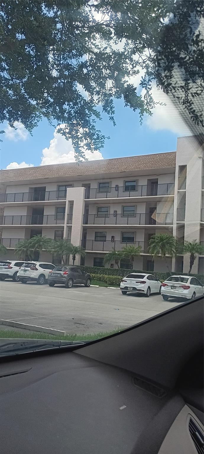 PRICE CHANGE FOR THIS Updated 2/2 with lake view from the glass enclosed patio! Beautiful corner unit located next to the elevator. Storage room is also next to the elevator and the condo. Property features redone kitchen with granite countertops; tile in living areas, enclosed patio with water view. In walking distance to the state of the art clubhouse with gym; theater, pool, game room, shuttle bus. This Clubhouse has shows, movies and classes.. Phase 4 has Washer & Dryer in unit. This unit is in Phase 4; the most sought after phase of Sunrise Lakes. This unit is on the top floor (4th) and overlooks 3 lakes, golf course and beautiful lawns and trees. Call for an appointment today!!