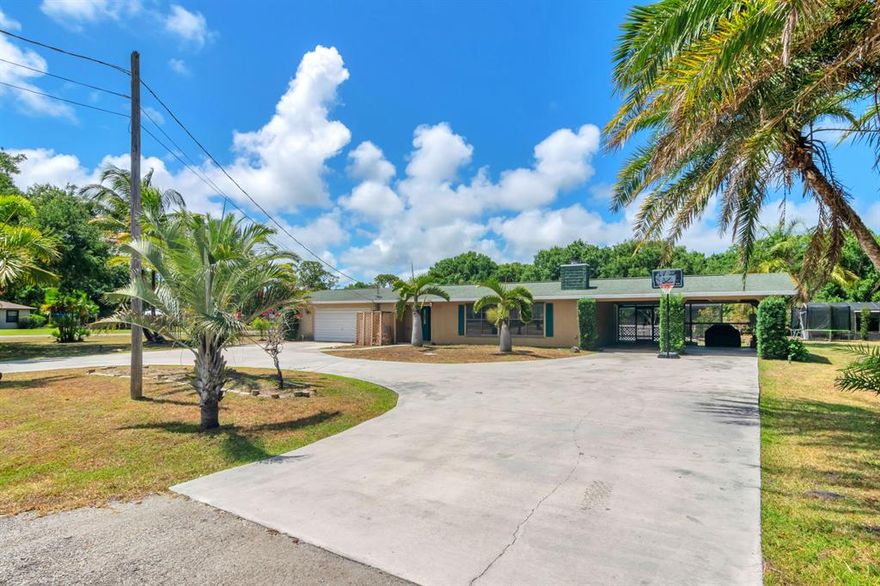 WELCOME HOME!
Beautiful home with 4 beds, 2 baths on a corner lot of ALMOST 2 ACRES home located in highly desired Indian Estates will surely impress you. This 2 car garage home also has an attached carport that could be made into a large room or just keep it as is to store your toys from this harsh Florida sunshine. Home has a large  living room plus an extra large entertainment room with a working fireplace. Walking past the entertainment room you will find a beautiful and fully remodeled kitchen. Exiting the kitchen or the entertainment room through the glass sliding doors you will find a very large screened in pool to entertain your most pickiest guests. Gorgeous newer wood plank tile flooring through out the home making this home light and bright. COME AND LET THIS HOME WOW YOU.