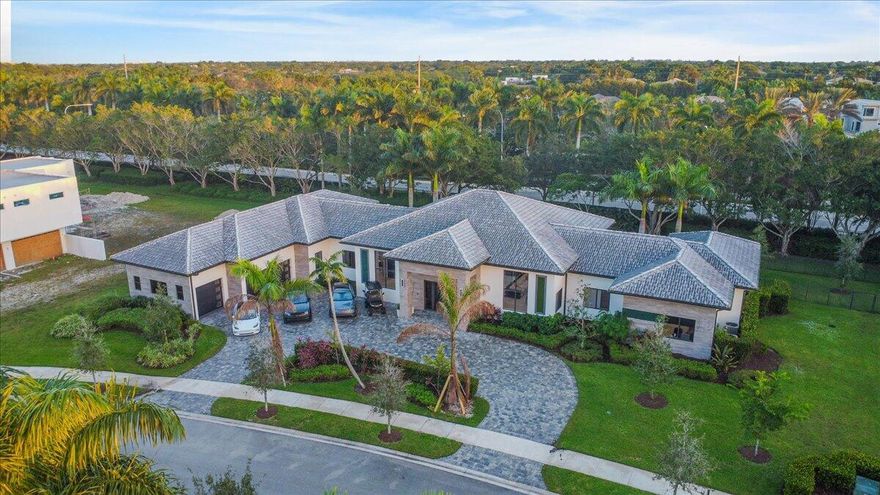 Situated among the Top 10 in Weston's prestigious ''Windmill Reserve,'' this sophisticated contemporary estate custom built in 2021 showcases 6 bedrooms and 6.5 baths within its expansive 6,000+ sq ft. Featuring a split floor plan with an oversized primary suite, his and hers walk in closets, Moen smart shower system, Thermador appliances, Chilled wine cellar for enthusiasts of fine wines, 14-foot vaulted ceilings, Built in surround system indoors and out, smart lighting throughout and led accent backlights create the perfect ambiance for entertaining and relaxation. Additional features include a 780 sq ft veranda overlooking a glistening pool with an oversized jacuzzi, three firepits, two outdoor showers, a full outdoor chef's kitchen, cabana room, 3 car garage, circular driveway, & more