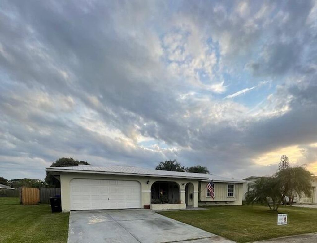 Photo of 308 NE Camelot Drive, Port Saint Lucie, FL 34983 (MLS # R10960619)