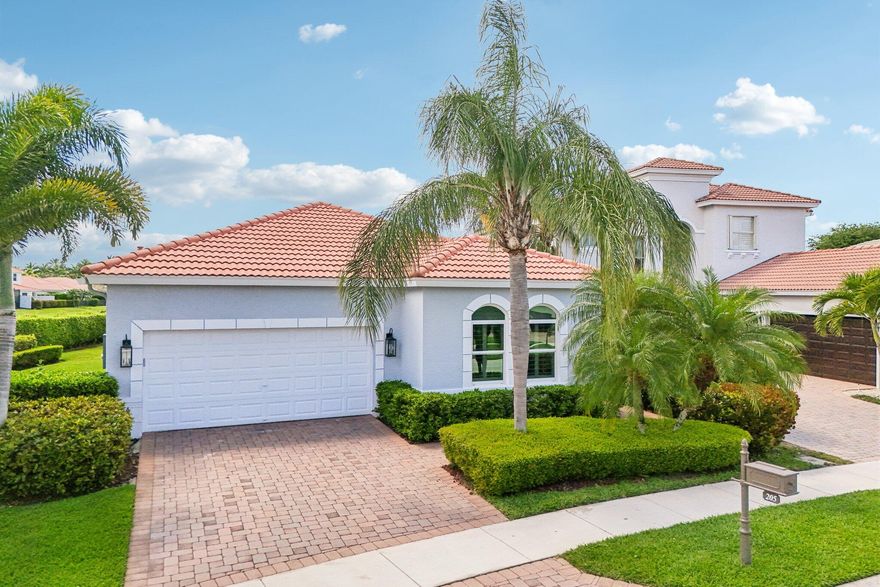 Welcome to 205 Via Condado Way—completely updated, move-in ready single-story waterfront home in Mirabella at Mirasol featuring impact windows and doors, whole house generator, and a private oversized lot with long lake views and no rear neighbors.  This extended El Prado model offers 3 bedrooms plus a dedicated office, 2.5 bathrooms, and a highly desirable open-concept, split-bedroom floor plan designed for both everyday living and entertaining. Light-filled interiors feature smooth finish walls, updated LED lighting, and no carpet throughout for a clean, modern feel.  The kitchen is finished with quartz countertops and stainless steel appliances and opens seamlessly to the main living areas, creating an easy flow for gatherings and daily living. All bathrooms have been fully renovated  with modern finishes, delivering a cohesive, turnkey interior.  Outdoor living is a standout with an extended covered patio, fenced backyard, and expansive water views—offering both privacy and space in a premium lakefront setting.  Additional highlights include a newer A/C system, custom built-ins in the living area and office, fully built-out closets, plantation shutters, electric shades, crown molding, and an epoxy-finished garage with wall storage.  Located in the gated, no-equity community of Mirabella at Mirasol, residents enjoy resort-style amenities including a clubhouse, fitness center, pool, clay tennis courts, kids' club and playground. Ideally positioned in Palm Beach Gardens with access to A-rated schools, world-class golf, shopping and dining at The Gardens Mall and Alton Town Center, and convenient access to I-95 and the Florida Turnpike.