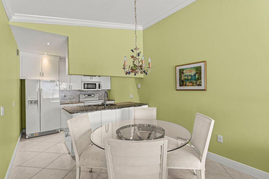 Picture yourself in this charming condo in fabulous South Florida Hypoluxo. Close to shopping, minutes from the pristine beach! Close to the highway & a short drive to the lively downtown area. Tastefully updated Kitchen with pull out pot drawers and spice drawer, Kitchen Aid appliances. With cabinets to the ceiling for more storage. There are also cabinets on both sides of the island for even more storage. Renovated bathrooms and newer modern tile floors throughout the home. Full size washer and dryer. Bright and light townhome. front door has an extra glass door for Maximum light.   Washer 2025. Electric Panel 2020. Water heater 2025. The painting over the couch in the living room is not part of the sale - all the other furniture is part of the sale.  Community amenities include a lovely pool and tennis court and Pickleball courts a Clubhouse and Library. Manager on site in the office. Gated community. Beautifully manicured parklike grounds throughout the neighborhood.