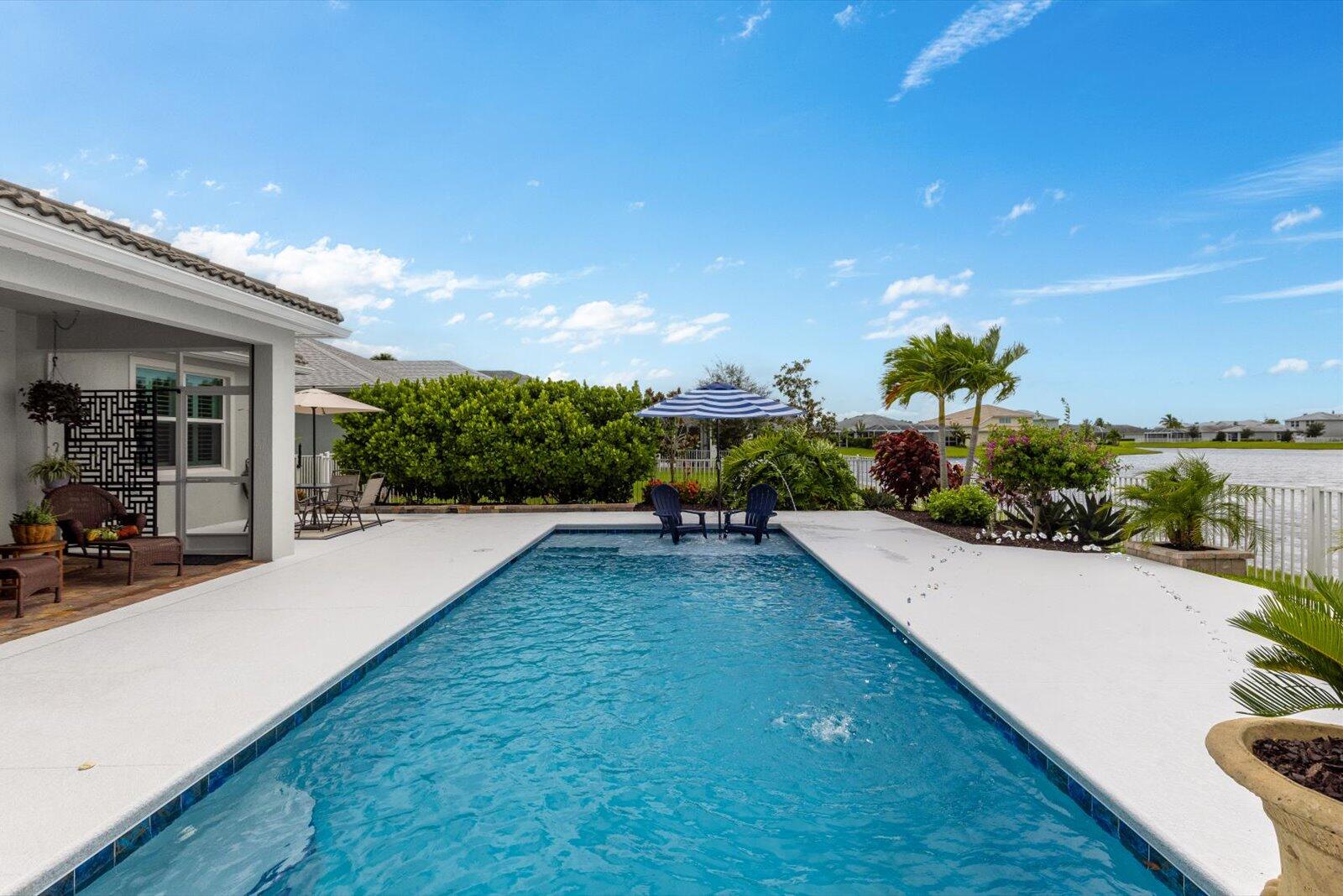 Too many upgrades to mention! Luxury meets lifestyle in this 3 bedroom / 2 bath lakefront pool home in Tradition's gated Heron Preserve! Heated/cooled pool with spa bench, dual arch fountains, and landscaping create a private oasis. Chef's kitchen offers 42'' cabinets, quartz counters, backsplash, and upgraded appliances. Owner's suite includes granite vanity, frameless shower, and walk-in closet. Interior features diagonally laid flooring, coded door lock, smart-home tech, security camera wiring, Lennox AC, and app-enabled garage door. Extended garage with plumbing, plus laundry utility sink, whole-house water softener, and storage. Community provides gated security, clubhouse, fitness, resort-style amenities, minutes to schools, Cleveland Clinic, world class shopping, and dining!