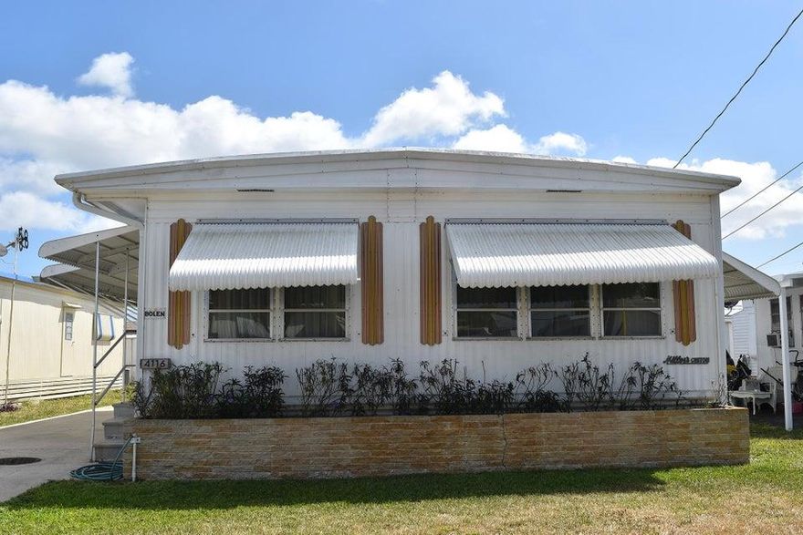 Unique, active 55+ mobile/manufactured home community. DEEDED lot with titled mobile home, low real estate taxes & low HOA ($775/YEAR). HOA includes water & community treatment. Large double-wide boasts eat-in kitchen, large LR w/dining area, bonus room, 2 BR & 2 BA. Attached enclosed porch houses washer/dryer. Central A/C in main building, room A/C on enclosed porch. Use DishTV satellite  or install Xfinity, either requires subscription. Cut-out in kitchen for dishwasher. Attached shed/workshop plus add'l storage shed. Deep lot backs up to interior Canal #L22. No lease 1st 3 years. Max. 2 small pets under 40 lbs. Community Clubhouse offers social activities, holiday gathers, shuffleboard, arts & crafts. Being sold AS-IS with right to inspect. Room sizes approximate, buyers must verify.