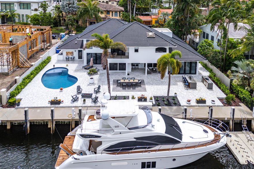 WOW - BEST PRICED WATERFRONT HOME IN THE ISLES! Experience the pinnacle of waterfront luxury in this fully remodeled estate sited in close proximity to the Inlet and direct Ocean access with no fixed bridges with plenty of room for your boat of any size with 100 feet of waterfrontage! Featuring an expansive West-facing backyard with a brand New Dock & Seawall, a newly renovated pool, built-in summer kitchen, and an enormous concrete deck providing ample space for entertaining, enhanced by picturesque sunset views. Step inside and be captivated by this designer inspired home with flawless attention to detail, providing a harmonious blend of form and function. The chef's kitchen boasts a gas stove, double oven, two dishwashers and expansive waterfall countertops. Stunning Porcelanosa bathrooms with spa-inspired touches like a large steam shower, and new custom closets throughout. Enjoy peace of mind with a 2018 roof, four A/C zones from 2023, and full hurricane impact windows and doors including an oversized retractable slider. Located on the South-Side of the Isles just minutes to the beach and downtown, this unique interior and exterior design creates an oasis that feels miles away from the city while still being at the heart of it all.. A must see!