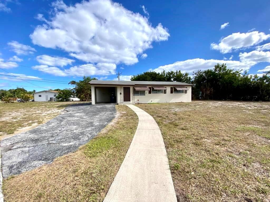 Photo of 861 W Ilex Drive, Lake Park, FL 33403 (MLS # R10874286)