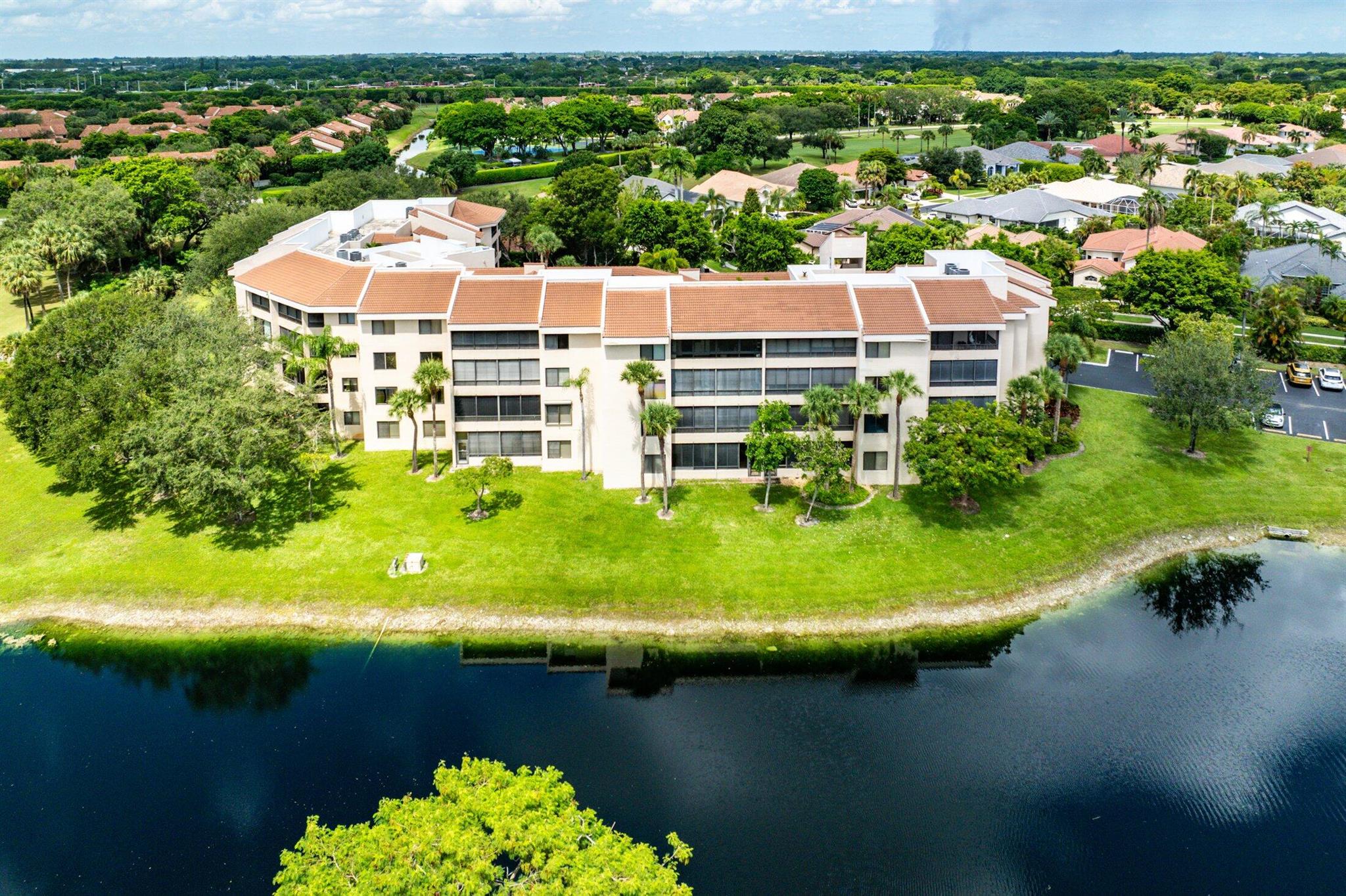 Immaculate rare modern condo with 2 bedrooms and 2 bathrooms encompassing 1,601 sq ft of living space and located on the top floor (4th) and therefore has 9.5 foot ceilings with the most impressive lake and golf course views! This magnificent condo has been updated with everything! Well-appointed that will impress the most demanding buyers! Updated kitchen, appliances, floors, bathrooms, window treatments and more. Florida room was eliminated to make for a much larger living area. Storage closet near elevator. La Paz has 2 pools, 2 tennis courts, and clubhouse. One assigned covered parking space and plenty of guest parking. Boca Pointe is a gated community featuring golf, dining, social events, fitness center, resort-style pools, tennis and pickleball courts. Membership is NOT mandatory.