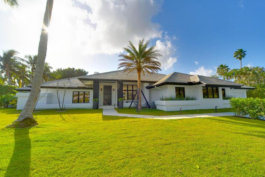 A true must-see, one of the most original and expertly renovated homes in the prestigious Palm Beach Polo Club. Enter through the eleven foot black barn door, to experience true indoor-outdoor living in this stunning six bedroom, seven and a half bath home. The renovation left no detail spared, including white oak flooring throughout, wood burning fire place in the living room, Thermador and Bosch appliances, and a full-sized Allavino wine refrigerator. The open layout is perfect for entertaining, with a separate dining room and several living areas, including oversized bonus room, living room, family room, and a separate cozy den. Off the main living area enter the backyard through the Windoor stacking glass wall doors, to enjoy the gorgeous vistas from the distinct separate outdoor spaces, and appreciate the mature plantings, outdoor shower, and heated pool. The two bedroom guest cottage is perfect for visiting family members, in-law suite, or trainer's quarters. The property comes fully furnished and decorated with a mixture of modern and vintage furniture.