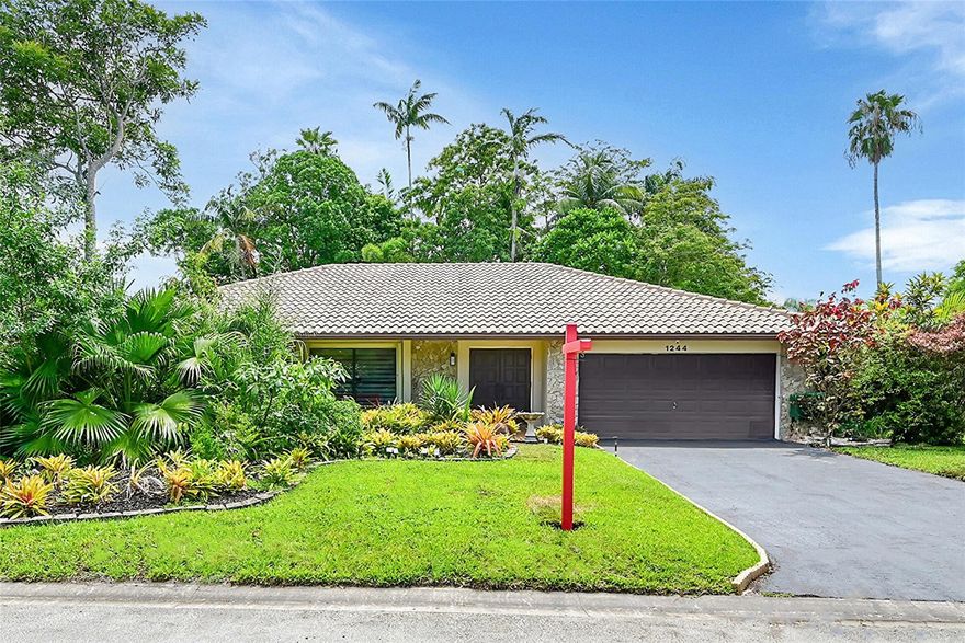 A Tropical Paradise! 4-bed, 2.5-bath home features an open, airy layout with abundant natural light thanks to desirable east-west exposure. The formal living & dining areas boast soaring vaulted ceilings, while the large open kitchen with newer appliances seamlessly connects to a breakfast nook & inviting family room. The split-bedroom floor plan with newer floors ensures privacy, with the expansive primary suite offering his-and-her closets and a en-suite bathroom with a walk-in shower. Step outside to an oversized screened-in pool perfect for relaxing or entertaining year-round.  Highlights include a New A/C (2025), full accordion hurricane shutters, 2-car garage. Situated by a lake, this well-maintained home provides peace, privacy, and exceptional value in a truly serene setting.