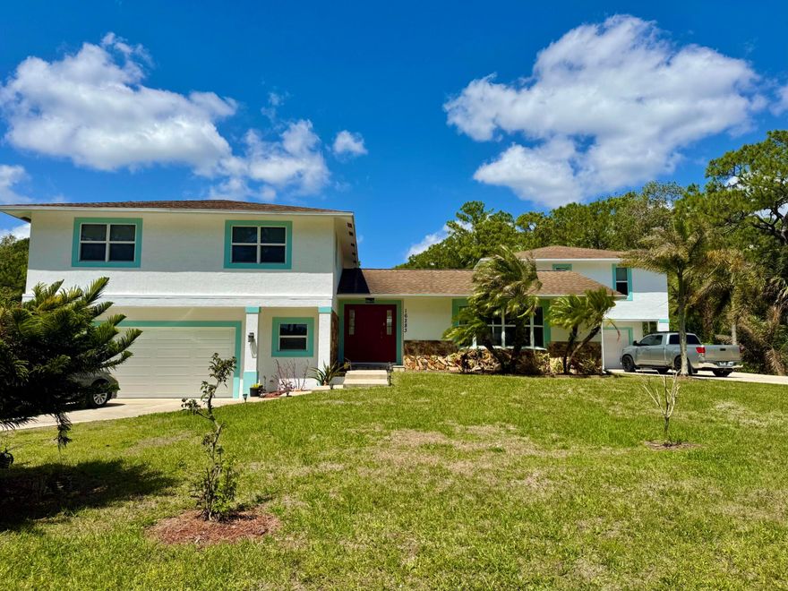 TWO HOMES for the Price of One! Well built & impeccably maintained Concrete Block home with Guest house located on over an acre in Jupiter Farms. The Main home offers an updated Kitchen with new appliances, 4 large bedrooms, 2 1/2 Bathrooms, Office, Garage, Impact glass Windows on upper floor and bay window, & screened patio. The detached CBS Guest house offers vaulted ceilings, Large Living Room with Full Kitchen, separate bedroom, full bathroom, laundry room, Gym, 1 Car Garage, private screened patio, ADA Stair/Chair Lift. This high & dry lot located on a paved road also has a regulation size Tennis Court, a detached 2 car garage workshop behind the tennis court & separate driveways for each home. Less than a 5 minute drive to A+ school, minutes away from beaches, rivers, shopping & more