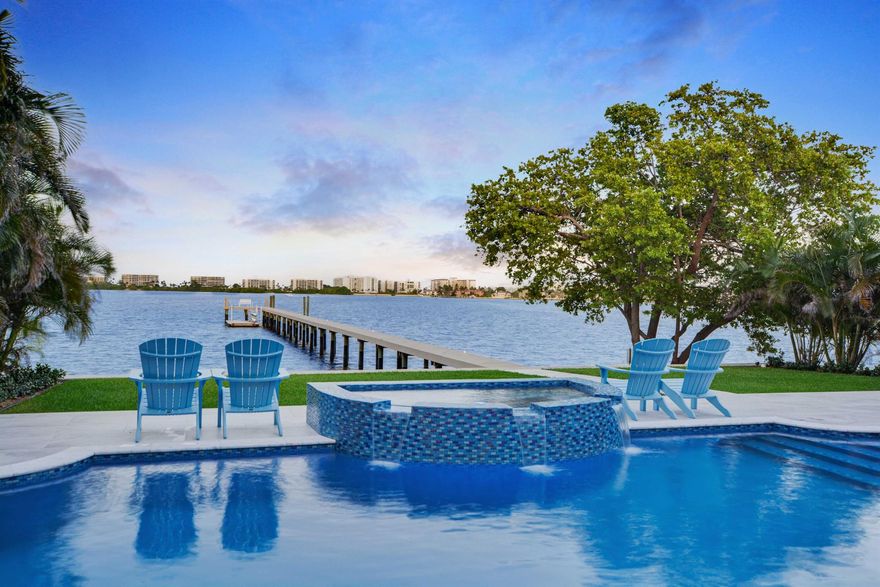 Discover the epitome of waterfront luxury in this exquisite 4-bedroom, 2/2 bath direct intracoastal home with riparian rights on the widest part of Lake Worth! Boasting a new, fortified 75-foot seawall and a 220 ft dock, prepare to be mesmerized by the panoramic views of the Intracoastal waters that stretch out before you. The fusion of indoor-outdoor living is achieved through the soaring 10-foot high sliding impact doors, creating a seamless transition to the sparkling pool, expansive patio, fabulous outdoor kitchen and enchanting dock.Renovated to perfection with meticulous attention to detail, this waterfront oasis radiates sophistication and elegance. Sunlight dances through the abundant windows, infusing every corner with a warm and inviting glow, ensuring that the water is n
