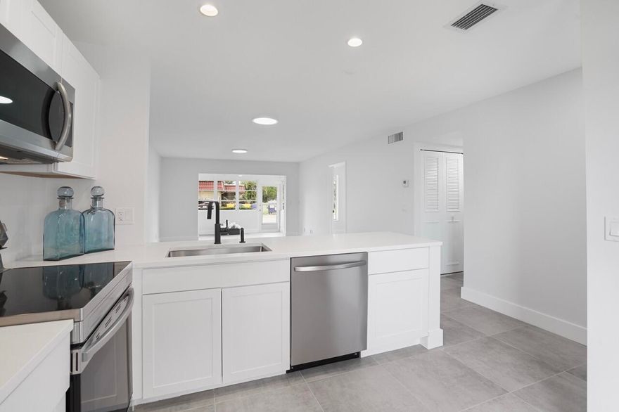 Beautifully renovated and move-in ready 2 bedroom, 2 bathroom residence located in the desirable 55+ community of Covered Bridge. This bright unit offers an open-concept living and dining area with a modern, clean design ideal for comfortable living. The updated kitchen features white shaker cabinetry, quartz countertops, stainless steel appliances, recessed lighting, and a spacious peninsula perfect for casual dining and entertaining. Neutral tile flooring flows throughout, creating a cohesive and low-maintenance space. Both bedrooms are generously sized, with ample closet space and updated bathrooms featuring contemporary finishes. Enjoy abundant natural light, modern fixtures, fresh interior upgrades, and a functional floor plan. Covered Bridge offers an active lifestyle with resort-style amenities including clubhouse, pool, tennis courts, walking paths, and social activities. Centrally located near shopping, dining, and major roadways. Ideal for full-time or seasonal living.