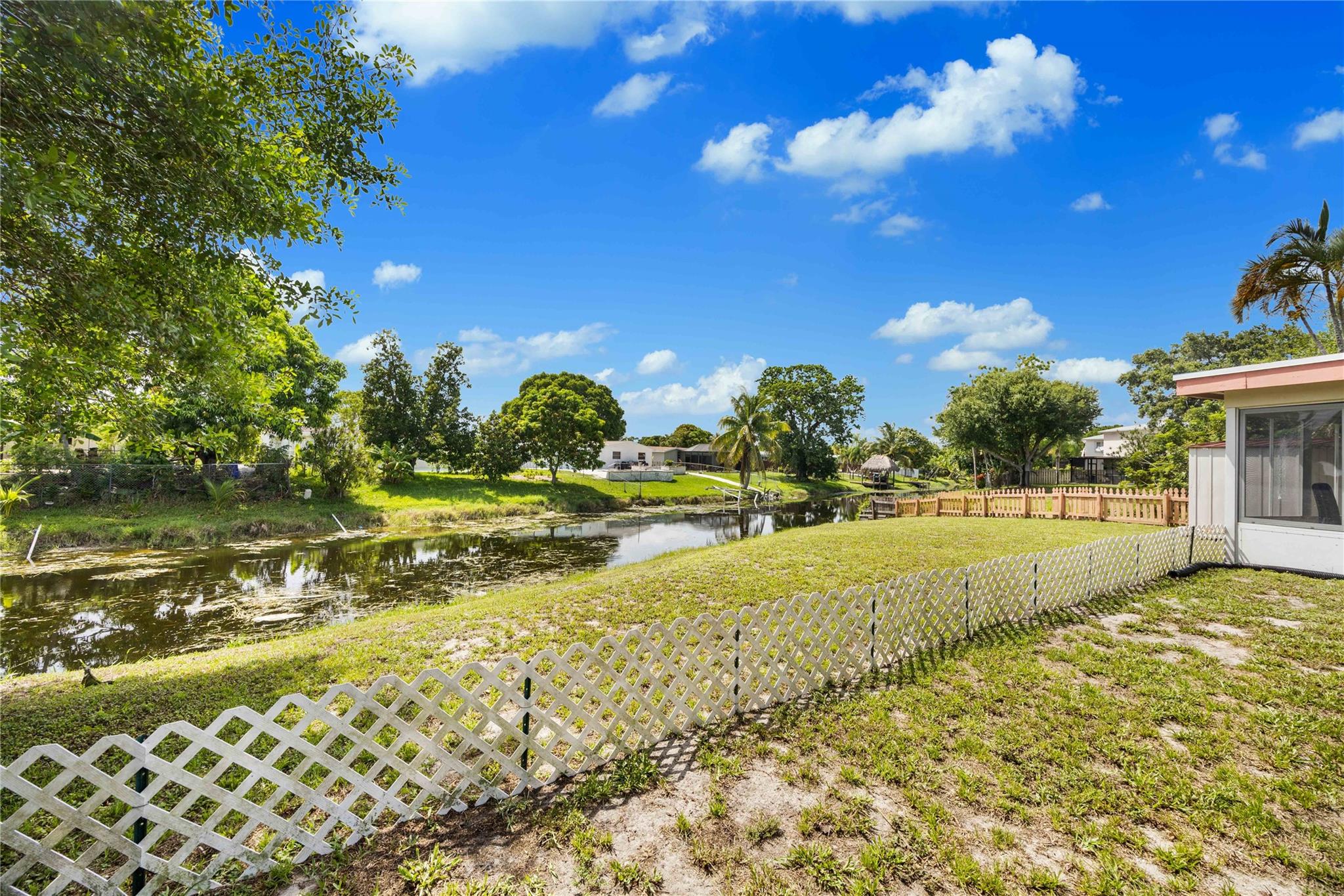 This is a charming semi-attached villa on an oversized lot, with a beautiful canal view. The side lot is very large and there is an enclosed patio, Florida room for additional space. The roof and AC are new. There is plenty of closet space and 3 bedrooms, perfect for family use.