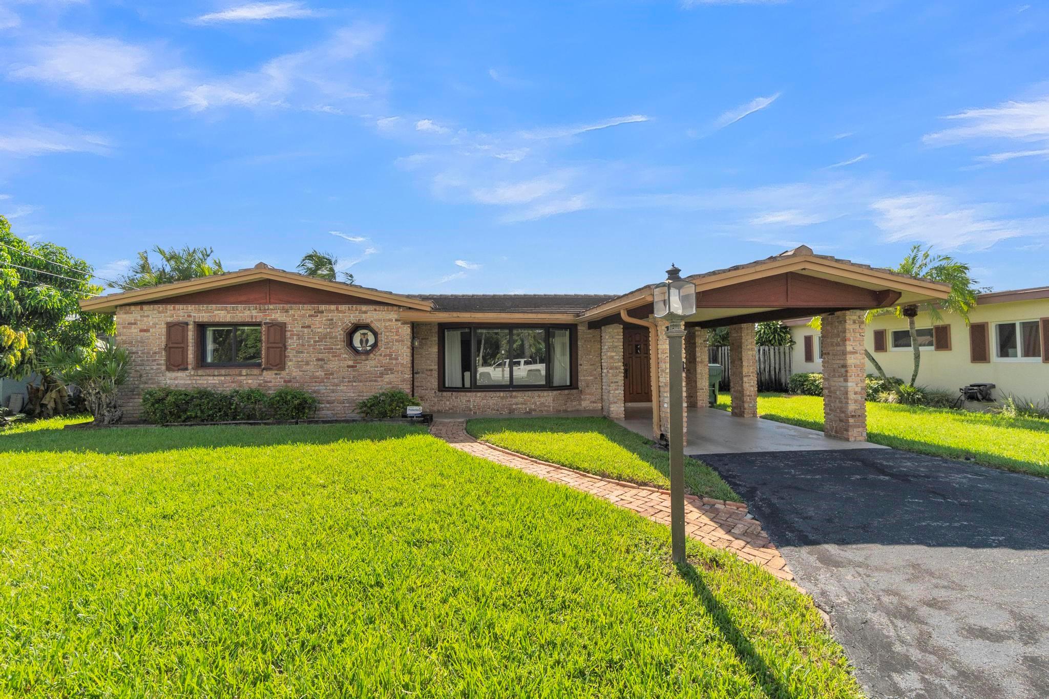 Treasure your stunning lake views from this 2-bedroom, 2-bath, 1-car carport lakefront home in Royal Palm Isles. Nestled on a cul-de-sac with ample yard space and room for a pool, this home is ready for your personal touches and vision. Enjoy a spacious kitchen with abundant counter space and cabinetry, plus separate living areas each featuring built-in wall units. The master bedroom offers both a walk-in and standard closet. Tile/flat roofs and impact windows were all installed in 2016, with shutters on the family room windows. Updated PVC water supply line providing perfect water pressure. The neighborhood offers one entrance/exit for a more private feel and is within walking distance to Royal Palm Park, Easterlin Park, Oakland Bark Dog Park, and Stunson Nature Trail.