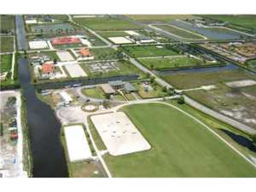 One of Palm Beach Point's premiere equestrian facilities situated on almost 16-acres of pristine land and equipped for all of your horse's needs.A stunning walkway leads to 24 spacious and immaculate stalls.Take the elevator upstairs to a three bedroom, two bathroom owners' apartment that boasts high ceilings, marble accents, wood floors, walk-in closets, and a beautiful open balcony.The grooms' apartment offers two bedrooms, 2 bathrooms, and a shared kitchen. Enjoy entertaining and relaxing on the private patio with pool and spa while surrounded by lush landscaping.Completely secure gated compound.