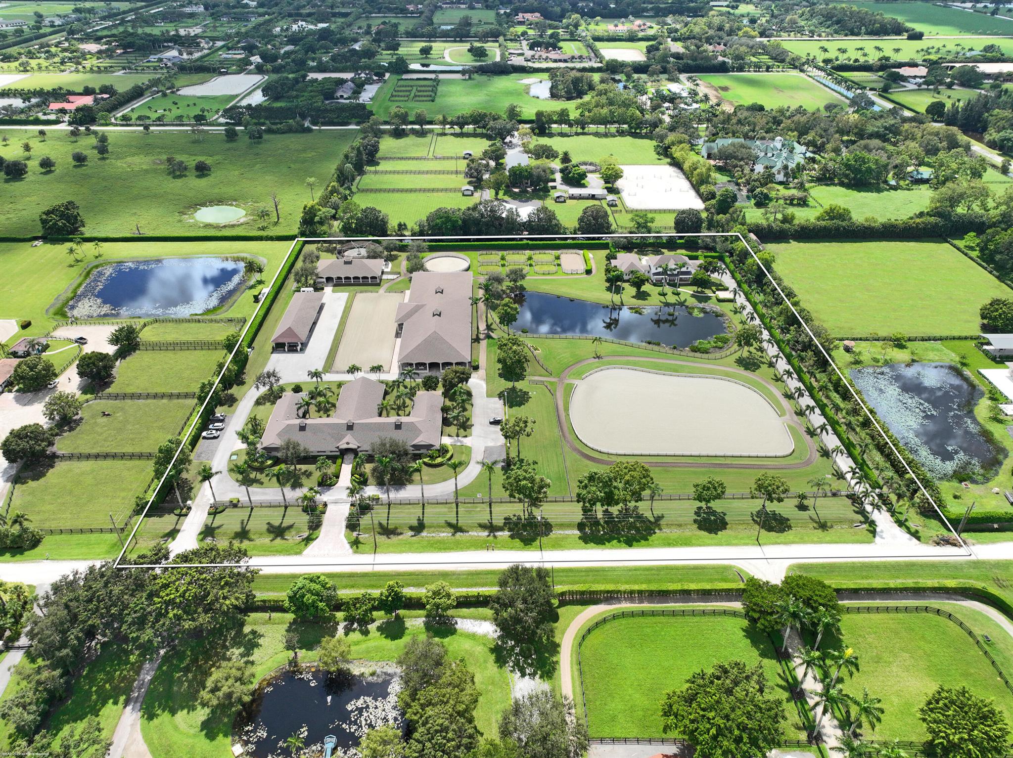 10.32 Acre equestrian property for the serious rider or professional of any discipline. Featuring a total of 25 stalls in two barns, covered riding arena with viewing patios, 2 outdoor arenas, exercise track, euro-walker, round pen, & large storage building. The center-aisle barn boasts 6 grooming & 2 wash stalls, 2 tack rooms, and 2 apartments with a total of 8 bedrooms. The 8 bedroom pool home has 5 bedrooms on the 1st floor & a 3 bedroom lock-off apartment upstairs with a full kitchen. The residence features a beautifully appointed center-island kitchen, primary bedroom suite w/ sitting room, & a stunning pool & patio with covered porch, perfect for entertaining. The main center-aisle barn has 17 stalls and 8 stalls in the back barn w/ it's own tack room, 2 tack stalls & 1 wash stall.