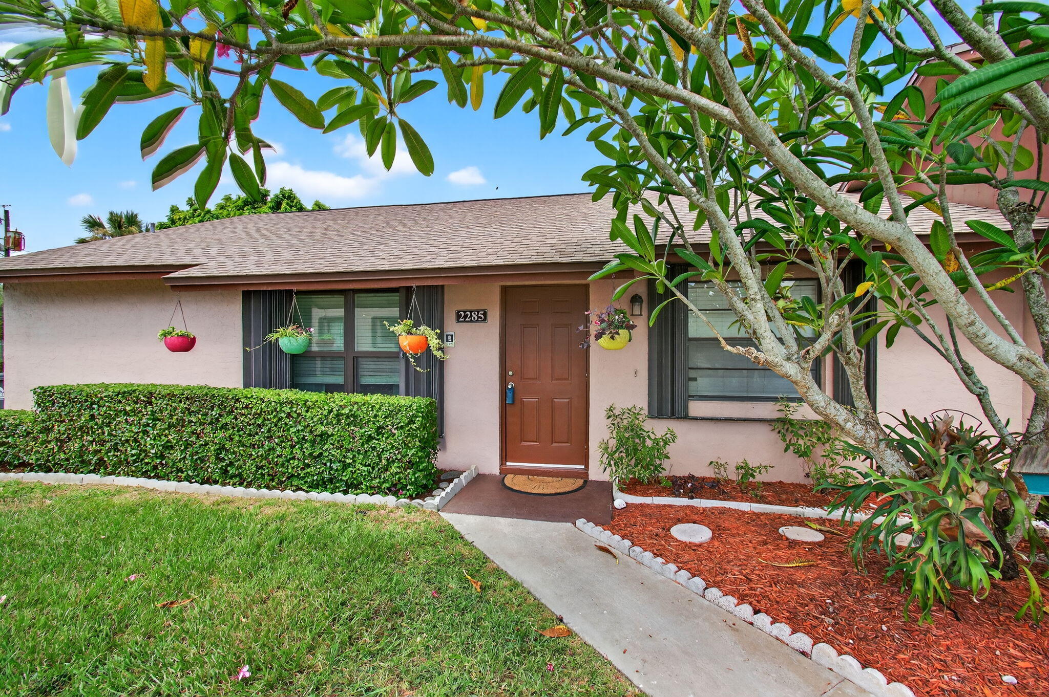 This spacious 3 bedroom, 2 bath villa offers over 1,200 sq ft of comfortable single-level living with modern updates throughout. A 2022 roof provides peace of mind, while hurricane impact windows in the living room and primary bedroom, along with accordion shutters on all windows, ensure added security and storm protection.The kitchen has been beautifully updated with white cabinetry, sleek countertops, and a new dishwasher (2025), creating a clean and timeless look. Both bathrooms have been refreshed with new vanities, stylish fixtures, modern toilets, and the guest bath features a newly designed walk-in shower.The open floor plan is filled with natural light, making the living and dining areas inviting for both everyday living and entertaining. The private patio offers
