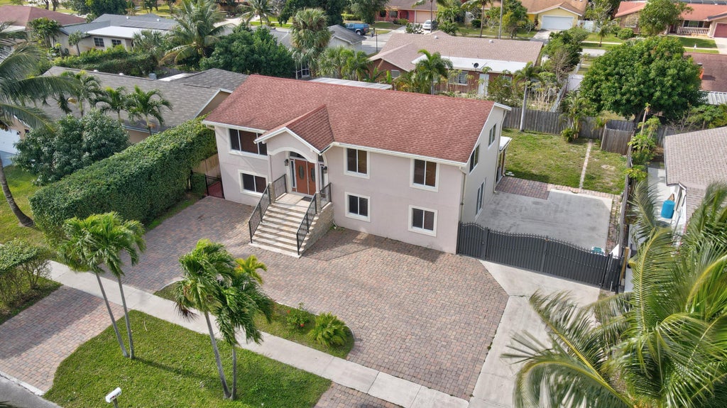 Photo of 1371 Woodcrest Road W, West Palm Beach, FL 33417 (MLS # B26076077)