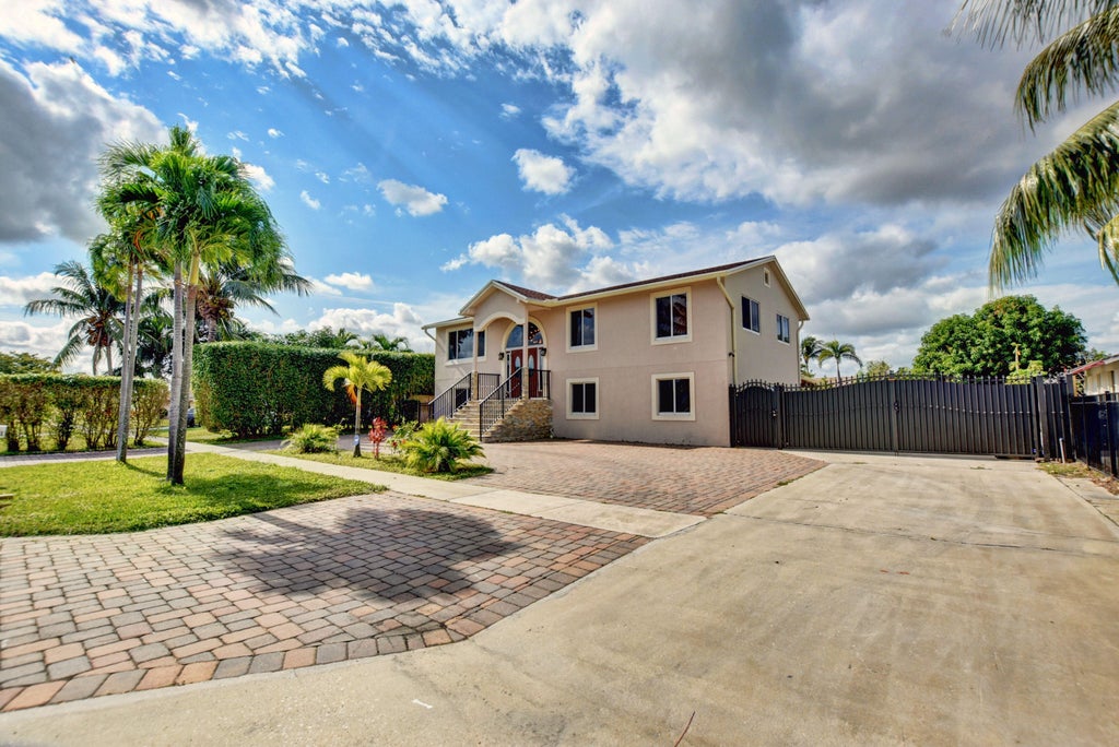Photo of 1371 Woodcrest Road W, West Palm Beach, FL 33417 (MLS # B26076077)