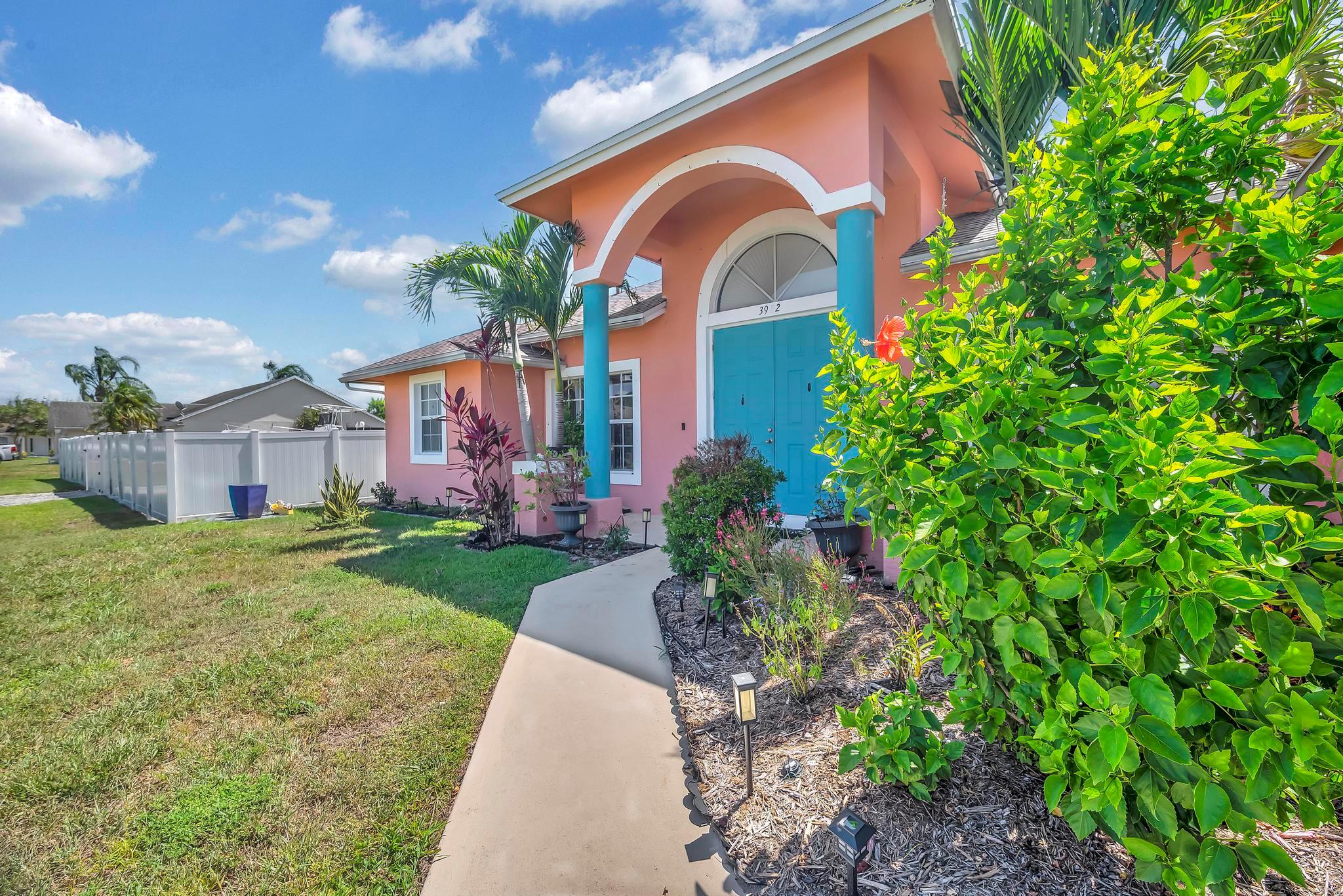 Welcome to your own slice of paradise in the heart of Port St. Lucie! This vibrant pool home offers the perfect blend of comfort, charm, and Florida lifestyle. Step into a spacious open floor plan highlighted by vaulted ceilings, abundant natural light, and a large kitchen perfect for entertaining. The owner's suite features a luxurious en-suite bath complete with a soaking tub, walk-in shower, dual vanities, and a makeup station, all accented by soft coastal tones and elegant finishes. Enjoy your days relaxing in the screened-in pool area featuring a beautiful rock waterfall, privacy fence, and plenty of patio space for lounging or outdoor dining. The lush backyard is fully fenced and landscaped with tropical plants, providing a serene oasis. Don't miss your chance to own this Home!