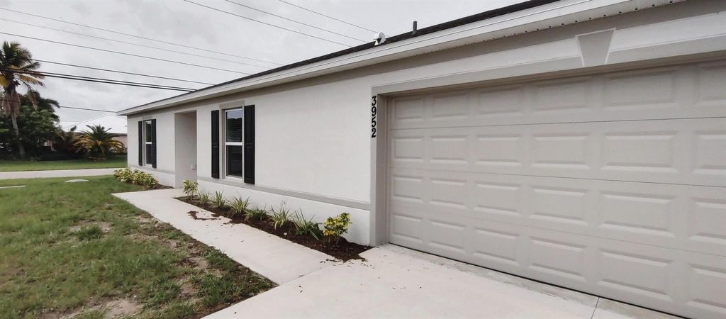 Photo of 3952 SW Kamsler Street, Port Saint Lucie, FL 34953 (MLS # R11010055)