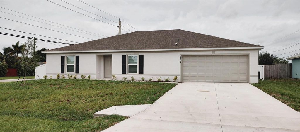 Photo of 3952 SW Kamsler Street, Port Saint Lucie, FL 34953 (MLS # R11010055)