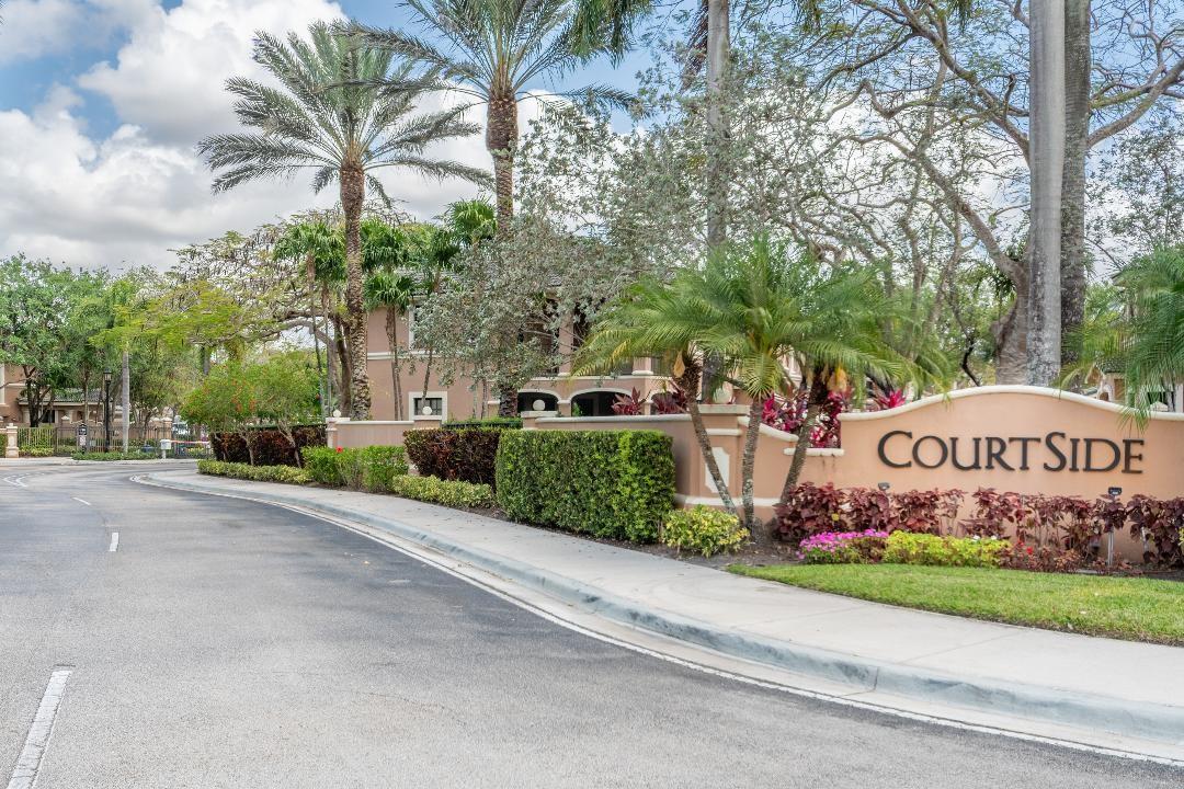 Beautifully maintained coach home in the exclusive Weston Hills Country Club. This desirable corner residence offers a private and extra-long driveway, 2 bedrooms + den, 2 full bathrooms, a 2-car garage, impact windows and an extended courtyard entrance. Enjoy a spacious screened patio ideal for relaxing or entertaining. The split floor plan provides comfort and functionality. Tile floors in living areas and laminate wood floors in bedroos. Located in the sought-after Courtside community within Weston Hills, residents enjoy a secure, gated lifestyle surrounded by golf courses and just a short walk to the club. A great opportunity to own in one of Weston’s most prestigious neighborhoods!
