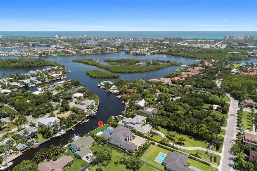 Immaculate waterfront estate home built in 2019 with direct ocean access and views of the Jupiter Lighthouse! This simply stunning 6 bedroom, 7.5 bath home was designed and decorated to perfection and is the epitome of South Florida waterfront living. The backyard was built for entertaining boasting a saltwater pool with infinity edge, fire features and floating steps to a sunken spa. Countless upgrades include custom millwork, a movie theater, a poolside water and fire wall and a whole house generator. Floor plan offers first and second floor grand master suites, first and second floor laundry and views of the water from nearly every room in the house. Minutes to the Jupiter Inlet! Bring your mega yachts or huge sport fishing boats to this fisherman's dream home.